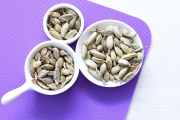 Dry cardamom seed (Elettaria cardamomum) displayed in containers