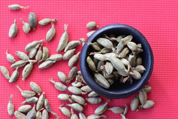Dry cardamom seed (Elettaria cardamomum) displayed in containers