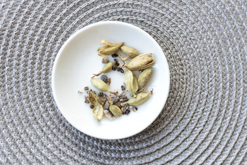 Dry cardamom seed (Elettaria cardamomum) displayed in containers