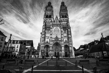 Fototapeta na wymiar Tours, France - 02/20/20 :Tours's cathedral. Cathedral Saint Gatien. Front of the cathedral taken in black and white. Wide angle picture. Evening picture.