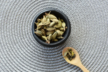 Dry cardamom seed (Elettaria cardamomum) displayed in containers