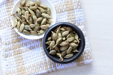 Dry cardamom seed (Elettaria cardamomum) displayed in containers