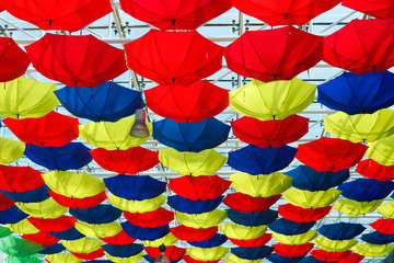 many colorful umbrellas hanging from the ceiling