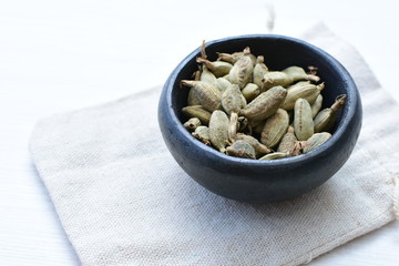 Dry cardamom seed (Elettaria cardamomum) displayed in containers