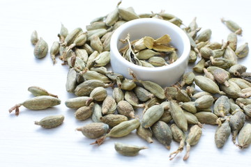 Dry cardamom seed (Elettaria cardamomum) displayed in containers