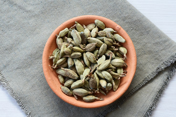 Dry cardamom seed (Elettaria cardamomum) displayed in containers