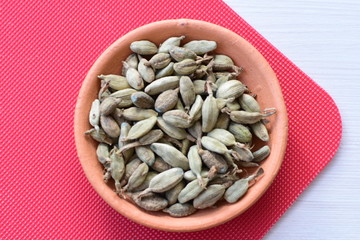 Dry cardamom seed (Elettaria cardamomum) displayed in containers