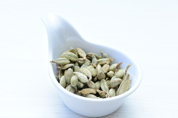 Dry cardamom seed (Elettaria cardamomum) displayed in containers