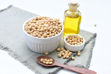 Raw soybeans (Glycine max) displayed in containers and accompanied by oil