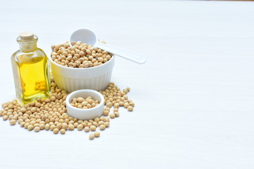 Raw soybeans (Glycine max) displayed in containers and accompanied by oil