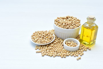 Raw soybeans (Glycine max) displayed in containers and accompanied by oil