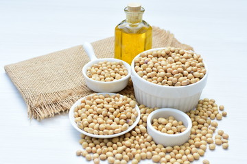 Raw soybeans (Glycine max) displayed in containers and accompanied by oil