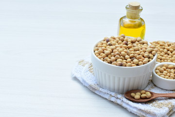 Raw soybeans (Glycine max) displayed in containers and accompanied by oil