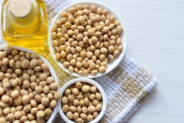 Raw soybeans (Glycine max) displayed in containers and accompanied by oil