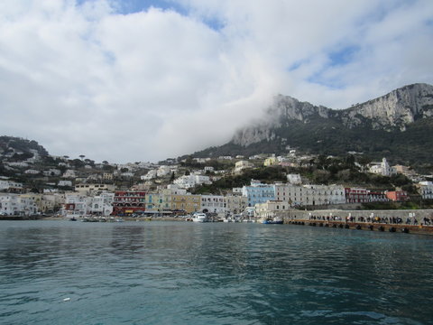 View of the coast and port of Capri, Italy on a sunny but cloudy day 
