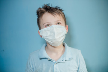 Masked child during COVID-19 quarantine. Ukrainian boy wearing protective mask epidemic Coronavirus Wuhan, Child protects PM 2.5 dust and air pollution or respiratory virus.