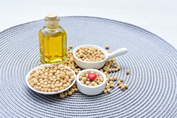 Raw soybeans (Glycine max) displayed in containers and accompanied by oil