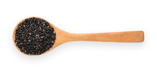 Black sesame seeds in wooden spoon isolated on white background.