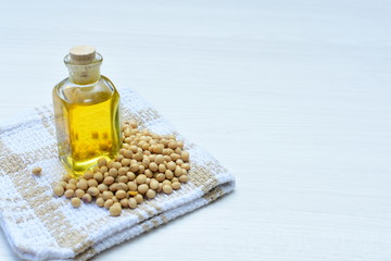 Raw soybeans (Glycine max) displayed in containers and accompanied by oil