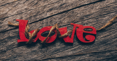 Love text wooden background