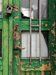 Detail of a green window frame ruined by time