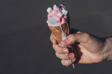 ice cream in hand isolated on grey