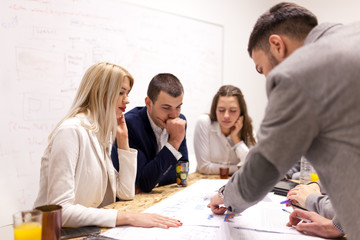 group of successful young architects and businessmen in modern workplace, having a creative meeting.