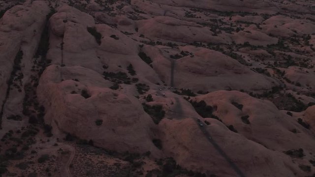 Offroading 4x4 Four Wheelers Driving Hell's Revenge Trail at Sand Flats Recreation Area Near Moab, Utah U.S.A. Aerial Drone Footage