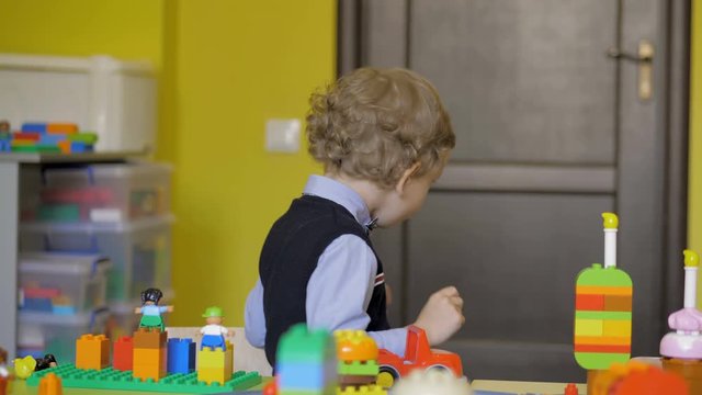 Children in the classroom make figures with teacher. Modern technology concept
