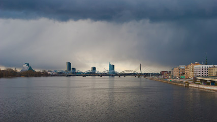 the city of Riga, the Daugava river, storm clouds