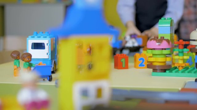 Children in the classroom make figures with teacher. Modern technology concept