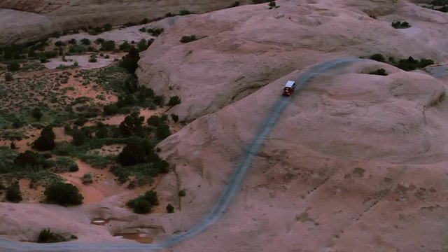 4x4 Offroading Four Wheelers Driving Hell's Revenge Trail in Sand Flats Recreation Area Near Moab, Utah USA Aerial by Drone