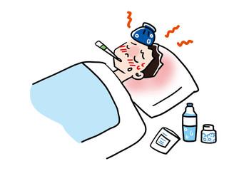 発熱し寝込む一人暮らしの男性が体温計をくわえている