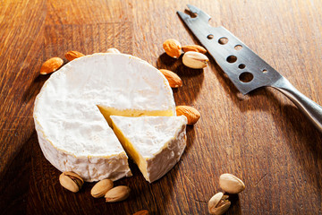 Camembert cheese or brie on wooden background.