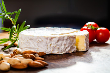 Camembert cheese or brie on wooden background.