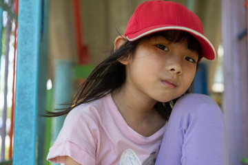 Fun happy child cute girl thailand Wearing red hats asian play on the playground in holiday