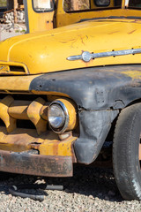 Fototapeta na wymiar Old rusty vintage yellow school bus headlight display