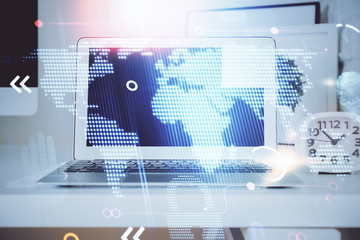 Multi exposure of table with computer and world map hologram. International data network concept.