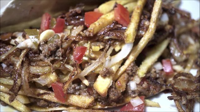 Close up panning on comfort food with meat and onion.