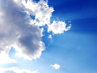 blue sky with white clouds and sun