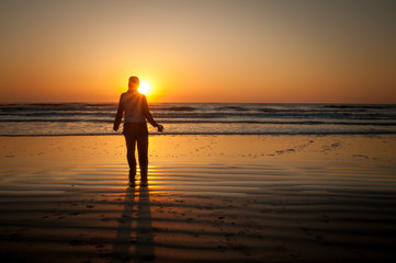 Fototapeta na wymiar silhouette of a woman at sunrise on Cumberland Island National Seashore