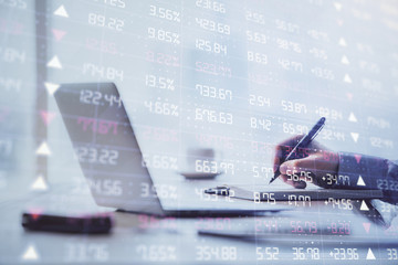 Multi exposure of forex chart with man working on computer on background. Concept of market...