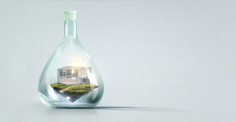 House and grass inside a glass bottle