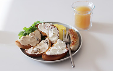 Bagel with cream cheese, sausage and pineapple