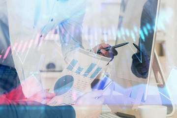 Double exposure of chart with businessman typing on computer in office on background. Concept of...
