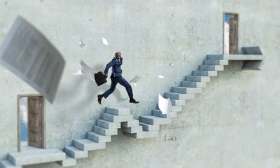 Black businessman climbing stone stairs illustrating career development and success concept. Mixed media