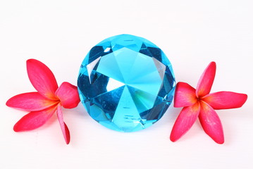 Blue diamond and Red Frangipani flower on a white background