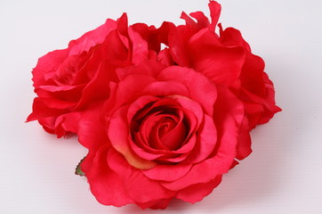 Artificial red rose on white background
