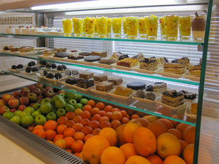 Fruits and desserts in an open fridge