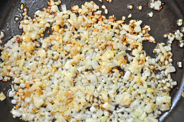 Diced onion fried in a pan
